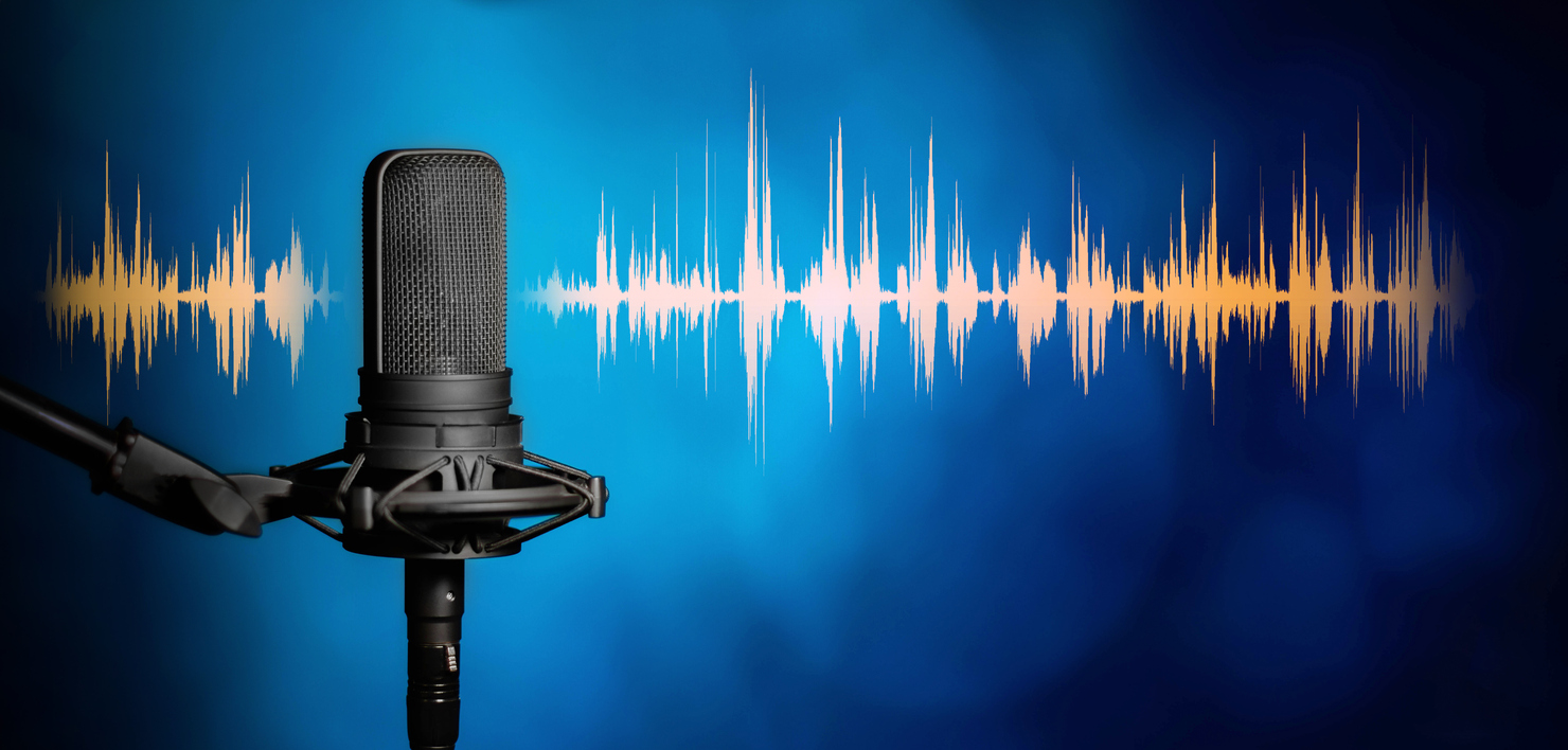 studio microphone on a blue background with audio waveform.